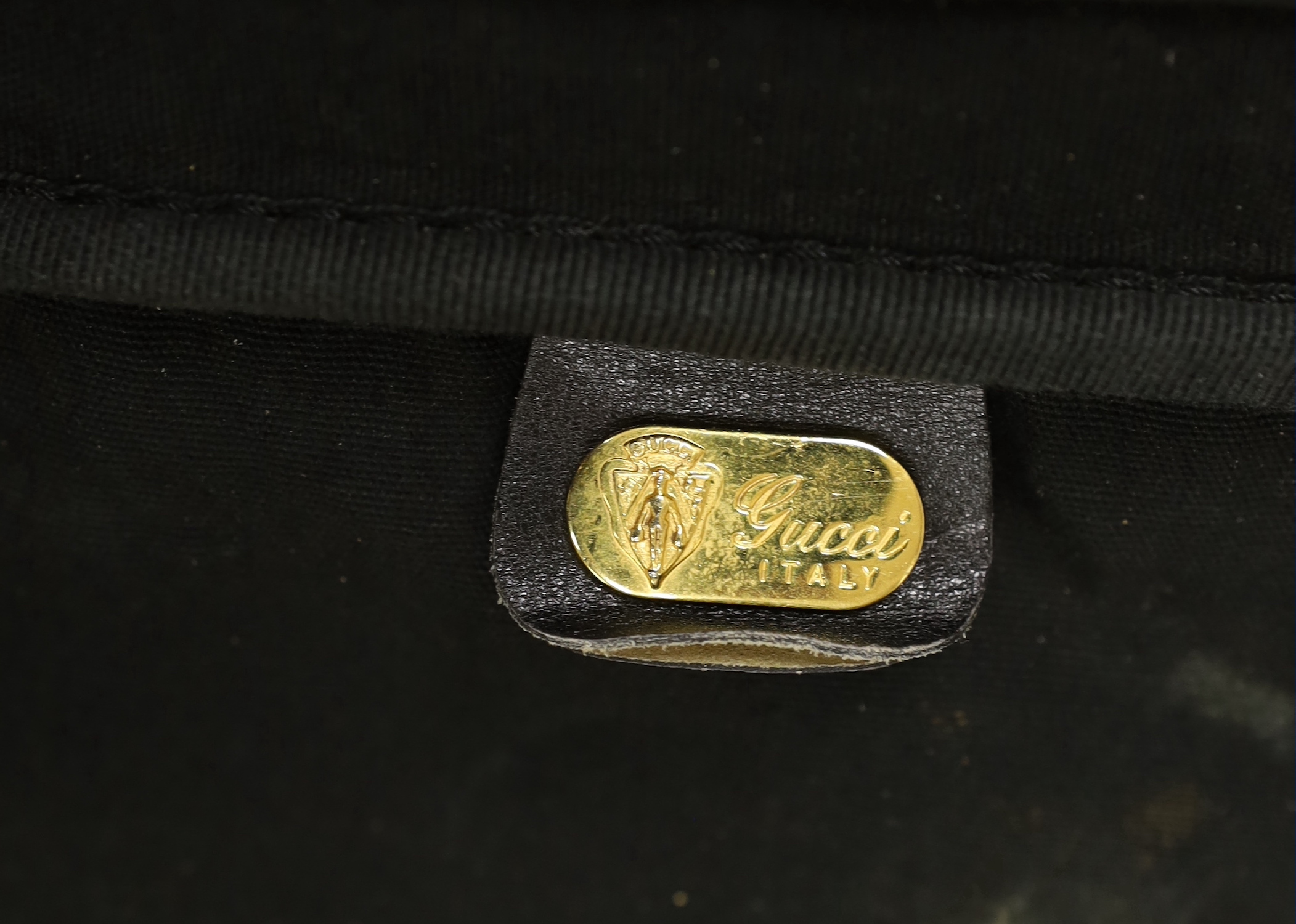 A black fabric and leather trimmed Gucci suitcase